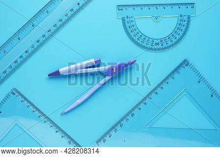 A Picture Of Geometry Set With Copyspace Sticky Note On Blue Background. Engineering And Mathemetics