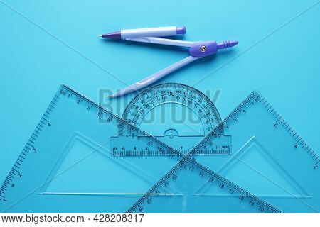 A Picture Of Geometry Set With Copyspace Sticky Note On Blue Background. Engineering And Mathemetics
