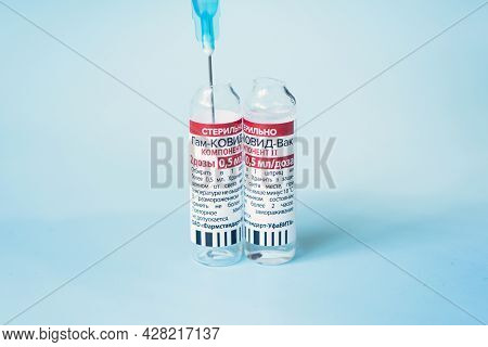 The Vaccine Sputnik V From The Coronovirus Infection Covid 19 On A Blue Background And A Syringe On 