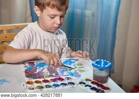 A Boy Draws With Paints At A Table In His Room. High Quality Fullhd Footagea Boy Draws With Paints A