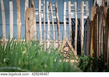 An Insect Shelter Has Been Installed On The Corner Of The Roof Of A Hut Near An Urban Vegetable Farm