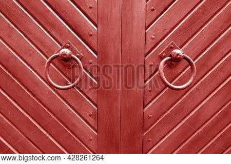 Old Metal Door Hinge On Wooden Door In Red Tone. Abstract Background And Texture For Design.