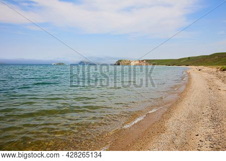 Beautiful Summer Landscape. The Shore Of Lake Baikal On A Summer Day. Calm, Clean, Transparent Water