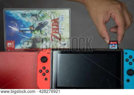 Samut Prakan, Thailand - July 29, 2021 : Close Up Of Man Inserting The Legend Of Zelda: Skyward Swor