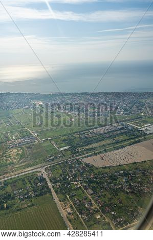 Land View Through The Airplane Window. Fields, Roads, Rivers From A Bird's Eye View. Porthole. Look