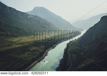 Misty Mountain Landscape With Wide Mountain River. Dark Green Gloomy Scenery With Confluence Of Two 