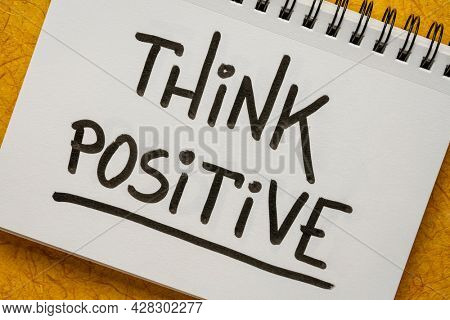 Think positive inspirational handwriting in a sketchbook, positivity, optimism and mindset concept