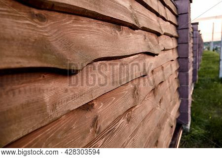 Unedged Planks Background. Wooden Scandinavian Fence. Brown Color Board. Grunge Texture. Flat Lay Mo
