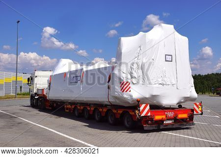 Oversize Load Or Exceptional Convoy. A Truck With A Special Semi-trailer For Transporting Oversized 