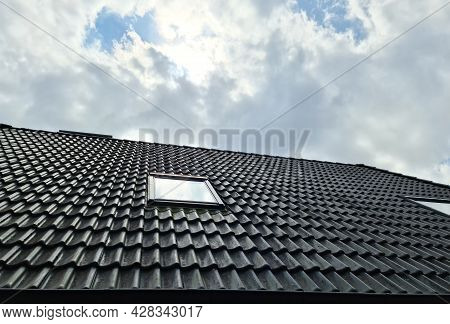 Open Roof Window In Velux Style With Surrounding Black Roof Tiles