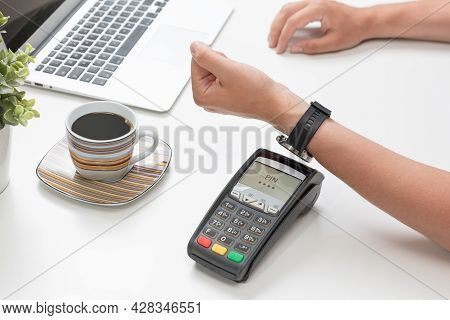 Man Pays By A Smart Watch In A Cafe Restaruant. Contactless, Convenient Form Of Payment