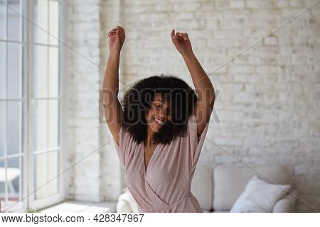 A Happy, Cheerful Young Mixed-race Woman Dancing Alone