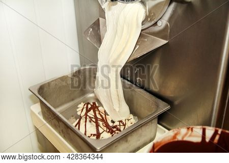Ice Cream Making Machine Produces Vanilla Ice Cream With Chocolate Dressing And It Falls Into Steel 