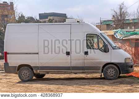 Old White Van For Builders At Construction Site