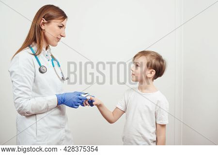Doctor Measures The Patient's Pulse And Oxygen Saturation To Young Boy. Concept Of Detection Of Asym