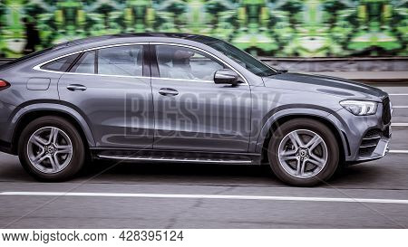 Moscow, Russia - April 2021: Side View Rolling Shot With Gray Car In Motion. Mercedes Gle Class Driv