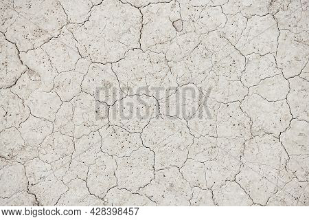 Cracked Desert Soil. Global Warming Concept. Arid Climate. Dry Dewatered Sandy Ground. Abstract Text