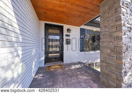 Entrance Exterior Of A House With White Bricks And Stone Bricks Column Post