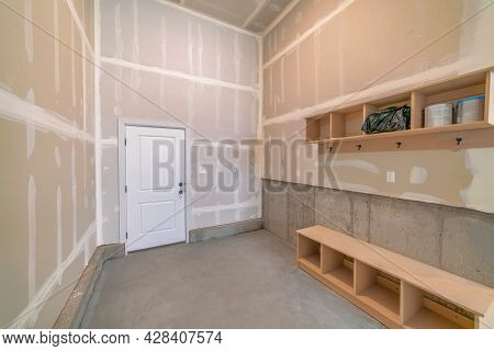 Unfinished Mudroom Interior With Seat And Shelving Units