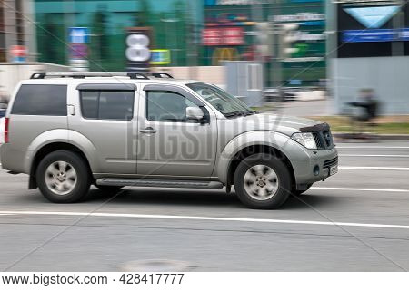 Moscow, Russia - April 2021: Side View Of Nissan Pathfinder R51 Suv In Motion. Gray 4x4 Car Moving O