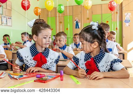 Krasnodar, Russia - September 1, 2020: First-form Schoolchildren In Classroom At School Desks On Hol
