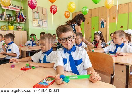 Krasnodar, Russia - September 1, 2020: First-form Schoolchildren In Classroom At School Desks On Hol