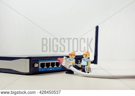 Billund, Denmark - July 15, 2021: A Close-up View Of A Technicians Connecting Lan Cable Into The Rou