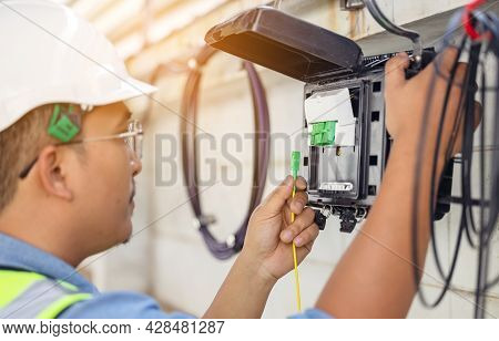 An Internet Technician Is Repairing Or Maintaining A Fiber Optic Connection By Opening A Fiber Optic