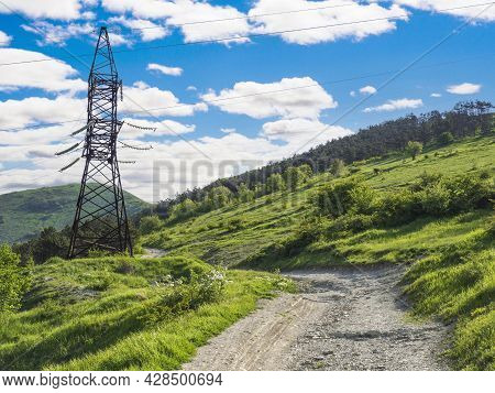 A Power Transmission Line Support With Wires In The Clouds On The Green Mountains Of The Krasnodar T