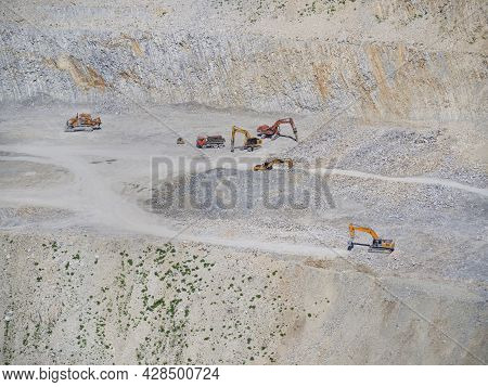 Many Industrial Excavators, Earthmoving Machines Extract Cement And Marl Rock In The Mountains Of No