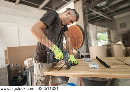 Carpenter Is Making Furniture In A Workshop