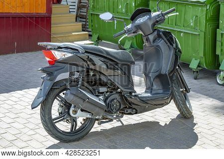 Black City Low-capacity Scooter Stands On The Street