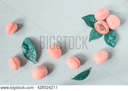Top-down View Of Fresh Pink Apricots With Leaves On Grey Plastered Surface. Tinted Photo.