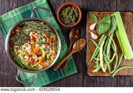 Soupe Au Pistou, French Vegetable Bean Soup With Basil Sauce Pesto And Herbs In A Metal Pot On A Dar