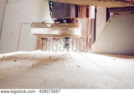 Cnc Machine At Carpentry Workshop. Cutting Wood With Various Router Bits.