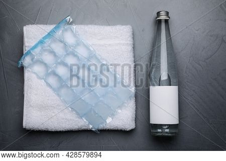 Bottle Of Water, Ice Pack And Towel On Grey Background, Flat Lay. Heat Stroke Treatment