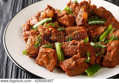 Ethiopian Cuisine Tibs Fried Beef Meat In A Spicy Vegetable Sauce Close-up In A Plate On The Table. 
