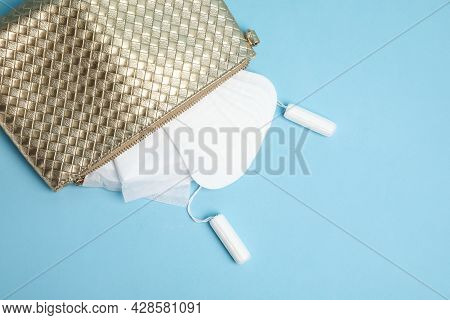 Bag With Menstrual Pads, Tampons And Pantyliners On Light Blue Background, Flat Lay