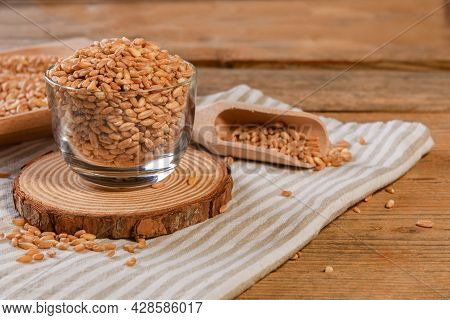 Wholegrain Uncooked Raw Spelt Farro On Glass Bowl On The Wooden Background