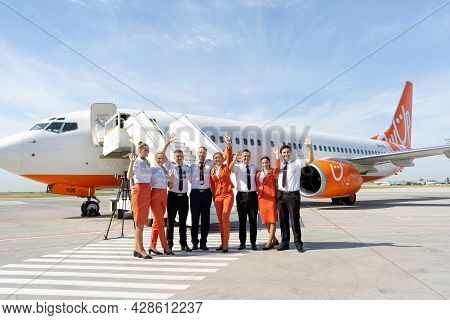 Ukraine, Odessa - July 16, 2021: Pilots And Stewardesses On The Background Of The Passenger Plane Bo
