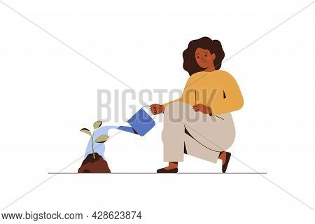 Girl Is Watering A Young Tree. Female Gardener Grows Plant. Green Economy And Forestation Concept. V
