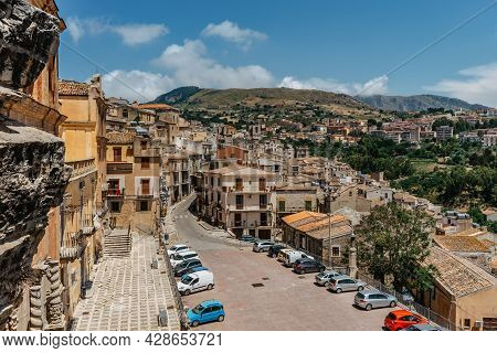Caccamo, Sicily, Italy. View Of Popular Hilltop Medieval Town And Piazza Duomo With Cars.medieval To