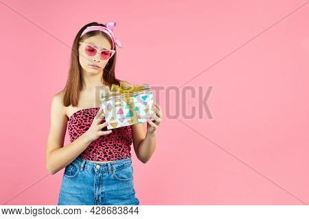 Young Smiling Happy Hipster Girl With Baces Holding Present Box Celebrating Party, Wearing Pink Sung