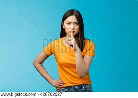 Hush Keep Quiet, Behave Well. Serious-looking Strict Asian Elder Sister Shushing Bending Towards Cam