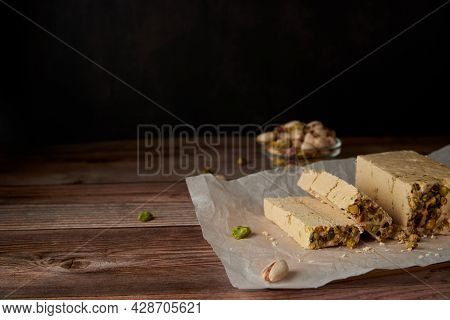 Organic Halva With Pistachios On A Wooden Surface. Traditional Middle Eastern Sweets. Jewish, turkis