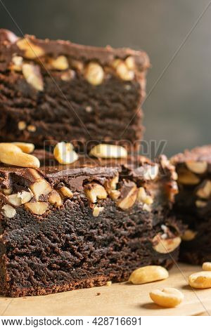Brownie With Nuts, Brown Chocolate Cake In A Close-up, Texture Cut, On A Dark Gray Background