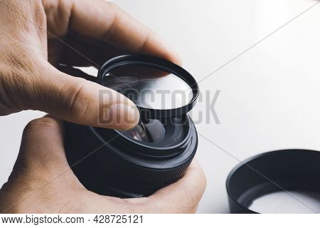 Human Hand Is Installing Uv Filter To Camera Lens