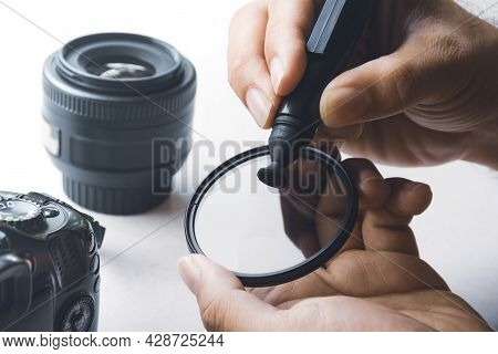 Human Hand Cleaning Stain On Cpl Filter Of Camera Lens With Carbon Brush Cleaner
