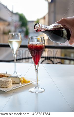 Drinking Of Kir Royal,  French Aperitif Cocktail Made  From Creme De Cassis Topped With Champagne, T
