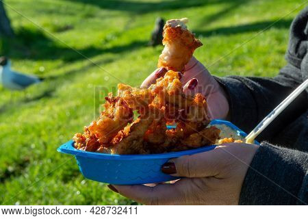 Eating Of Diep-fried Cod Fish Pieces Served With Remoulade Sauce